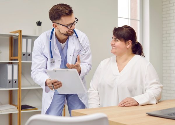 Overweight,Woman,Having,Consultation,At,Doctor's,Office.,Portrait,Of,Smiling